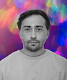 Man in monochrome portrait against a vibrant bokeh light background.