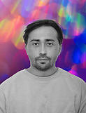 Black and white man's face with a vibrant colorful bokeh background.