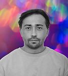Man in monochrome portrait against a vibrant bokeh light background.