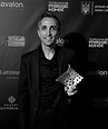 Smiling man holds geometric award at Міжнародний кінофестиваль Молодість, avalon sponsor.